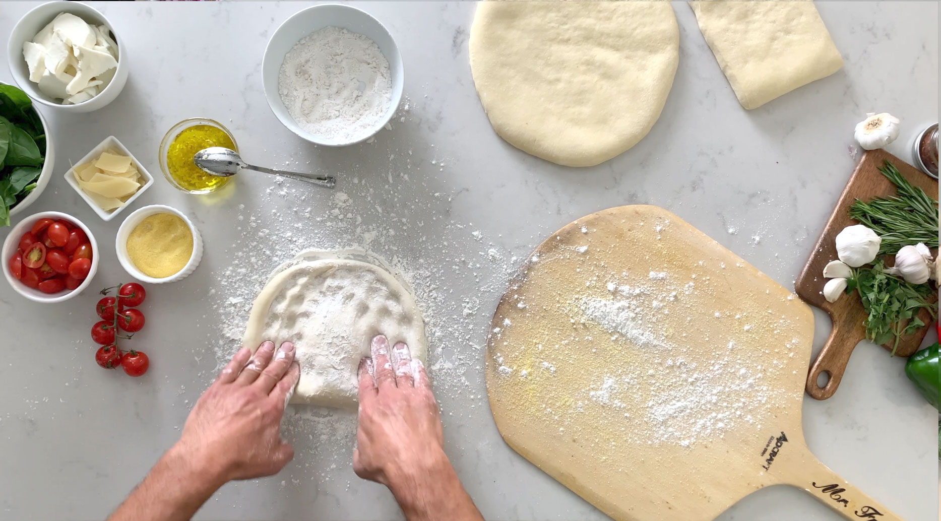 Dough Ball Pressed out on counter with pizza ingredients and pizza peel